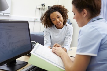 Nurse Discussing Test Results With Female Patient