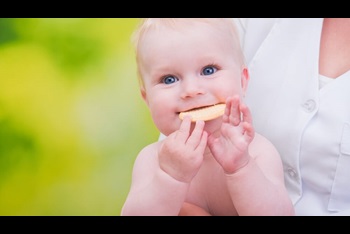 smiling funny baby eats cookies