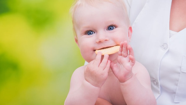 smiling funny baby eats cookies