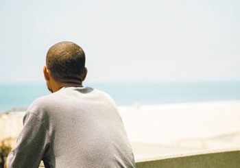 male looking out over a beach