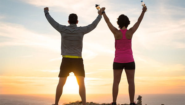 Couple celebrating active living during a sunset
