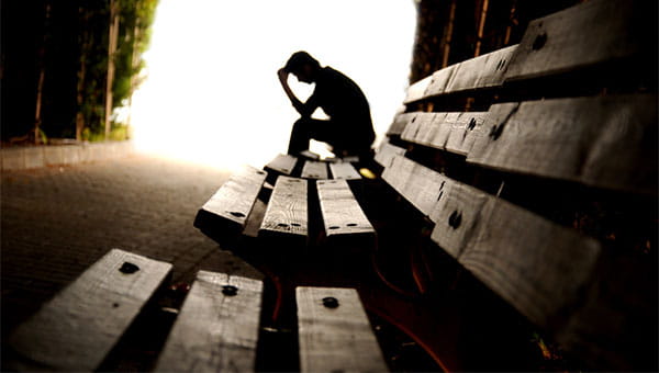 A man is sitting on a bench.