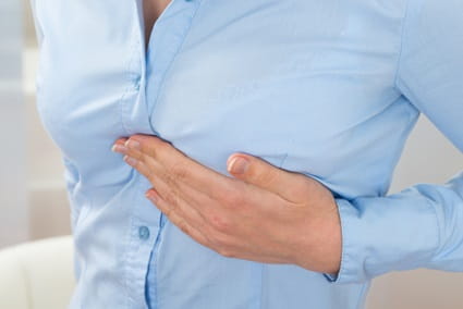 A woman is experiencing pain in her left breast.