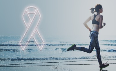 A female breast cancer survivor is running on the beach.
