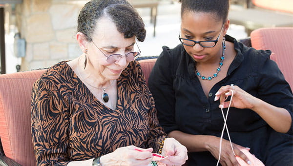 A granddaughter spends time with her grandmother.