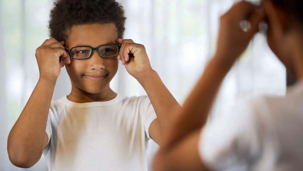 little boy looking at himself in the mirror