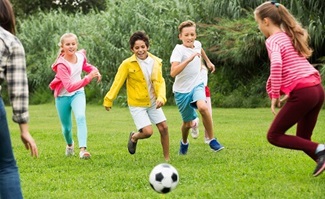 diverse group of kids playing soccer