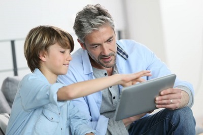 Father and son playing on a tablet