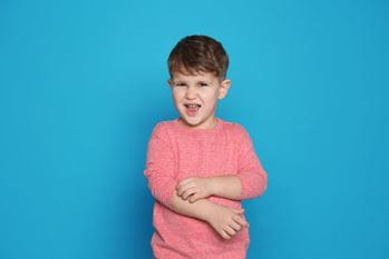 little boy scratching his arm