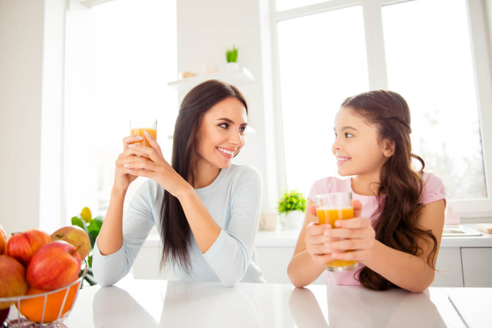 mother and daughter drinking healthy juice