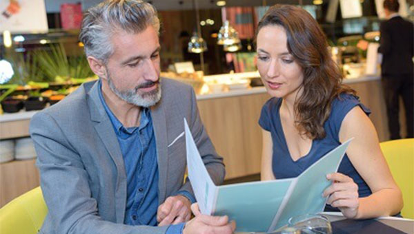man and woman reviewing a menu in a restaurant
