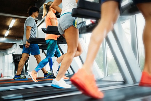 diverse group running on treadmills