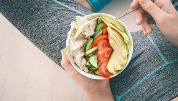 woman holding a salad on her lap