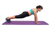 A woman is doing push-ups.