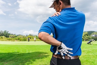 young male golfer having shoulder pain
