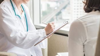 female patient speaking with a physician