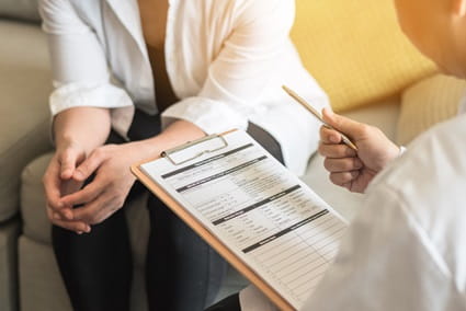 A woman is getting a screening for cervical cancer.