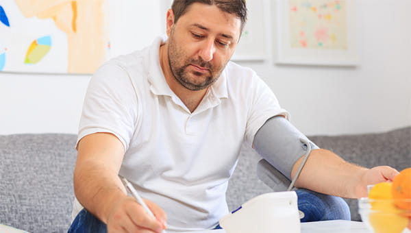 A man is checking his blood pressure