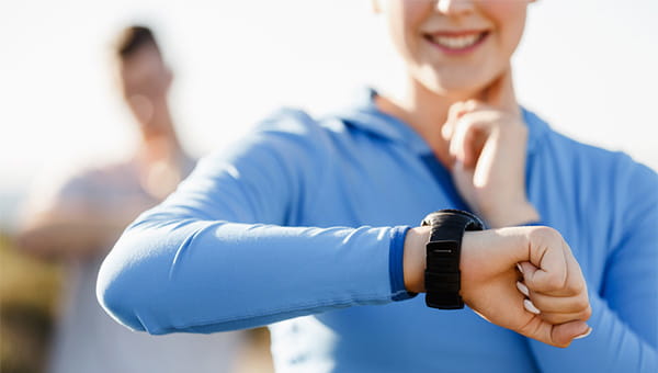 A woman is checking her heart rate after exercising.