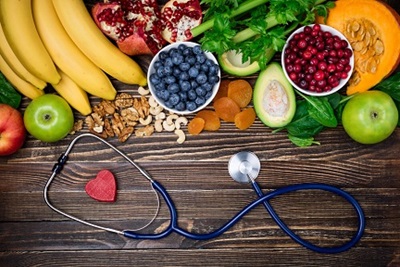 Variety of healthy heart foods and a stethoscope 