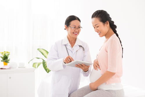 A doctor talking to her pregnant patient