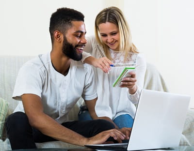 A woman showing her husband something on her phone