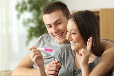 A young couple is looking at a pregnancy test