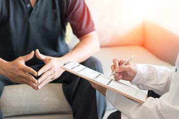 male patient speaking with a physician