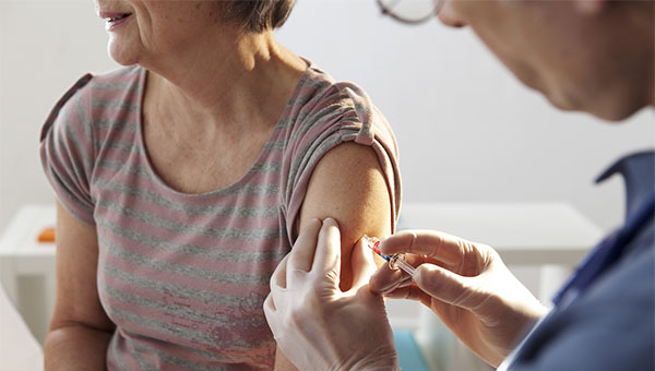 image of a women getting a shot in her arm