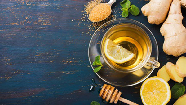 collage of ginger, lemon, honey and a glass of tea