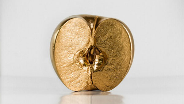 photo of an apple painted in gold