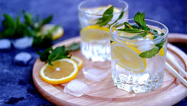 two glasses of water with lemons  and ice