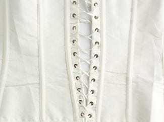 fragment of a white satin corset with lacing, wrong side of clothes