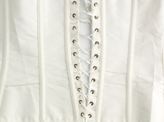 fragment of a white satin corset with lacing, wrong side of clothes