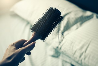woman holding out a hair brush
