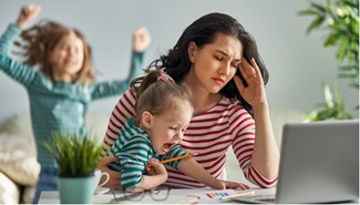 woman with children working at home stressed