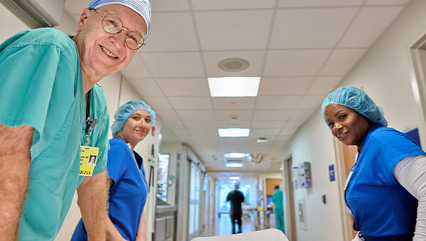 Physicians and Nurses looking and smiling at you as if you were laying on a gurney