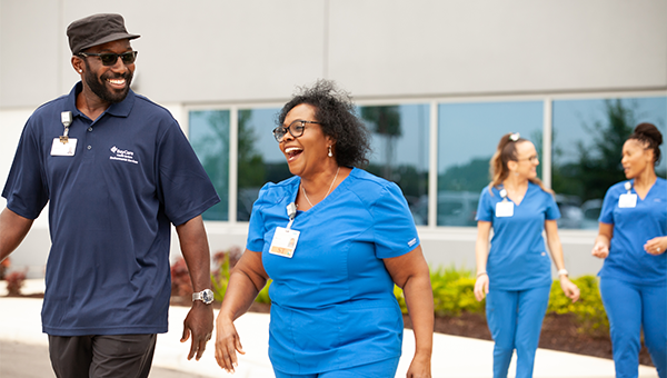 BayCare team members walking outside together happily.