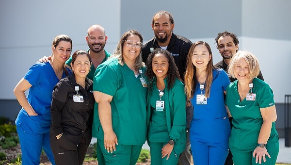 group photo of baycare professionals wearing different color scrubs