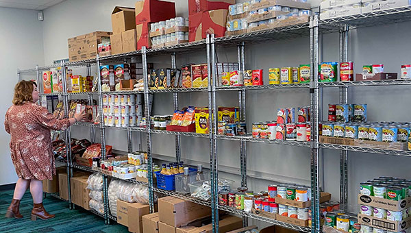 a photo of a woman stocking the eisenhower food pantry