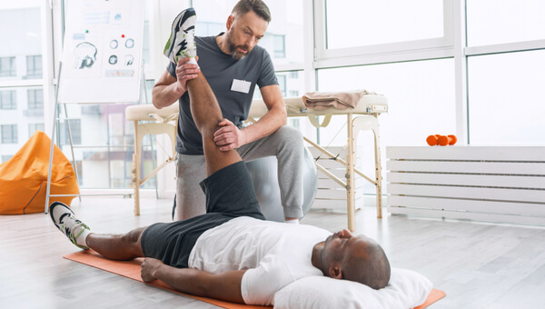 Male physical therapist working with male patient