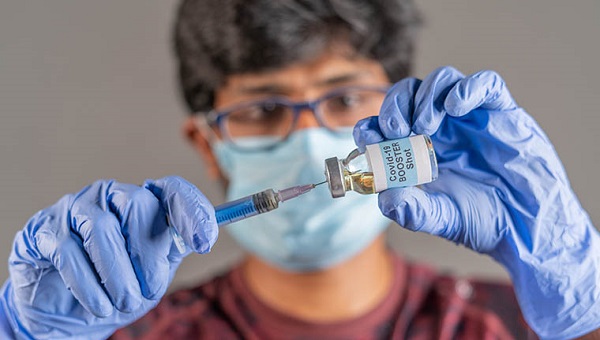 A healthcare provider is preparing to give a vaccination.