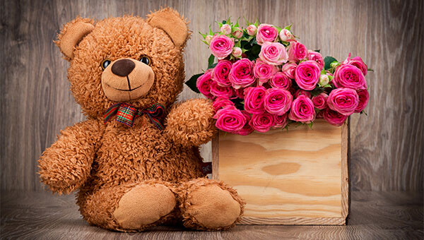 A teddy bear and flowers