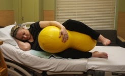 A woman demonstrating a maternity birthing position, option 4