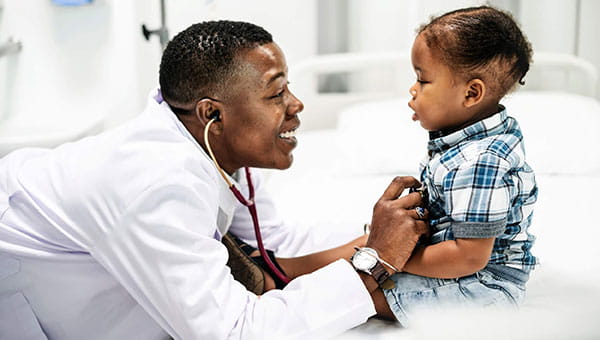 Physician examining baby