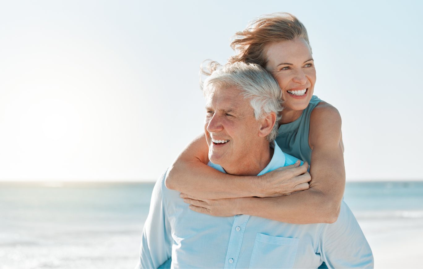 Adult man and woman on the beach smiling