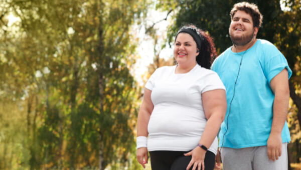 a man and woman walking outside together