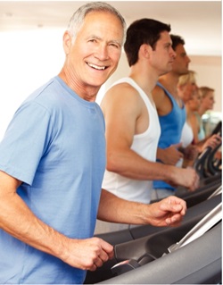 Man in a blue shirt walking on a treadmill