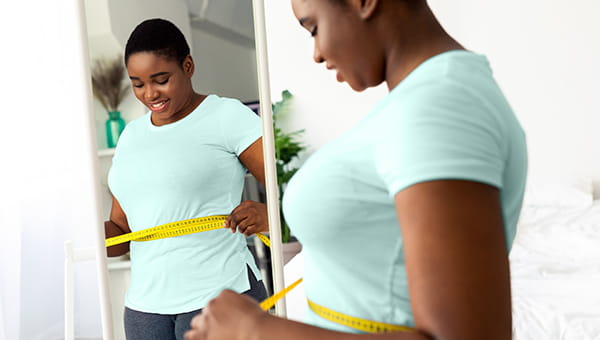 A woman happy with her weight measurements 