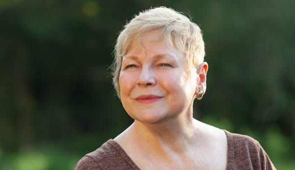 A senior standing outside looking at the camera
